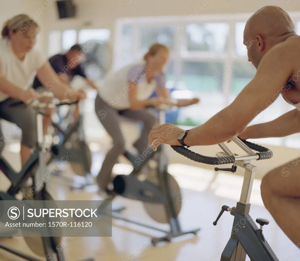 People using exercise bikes in a gym