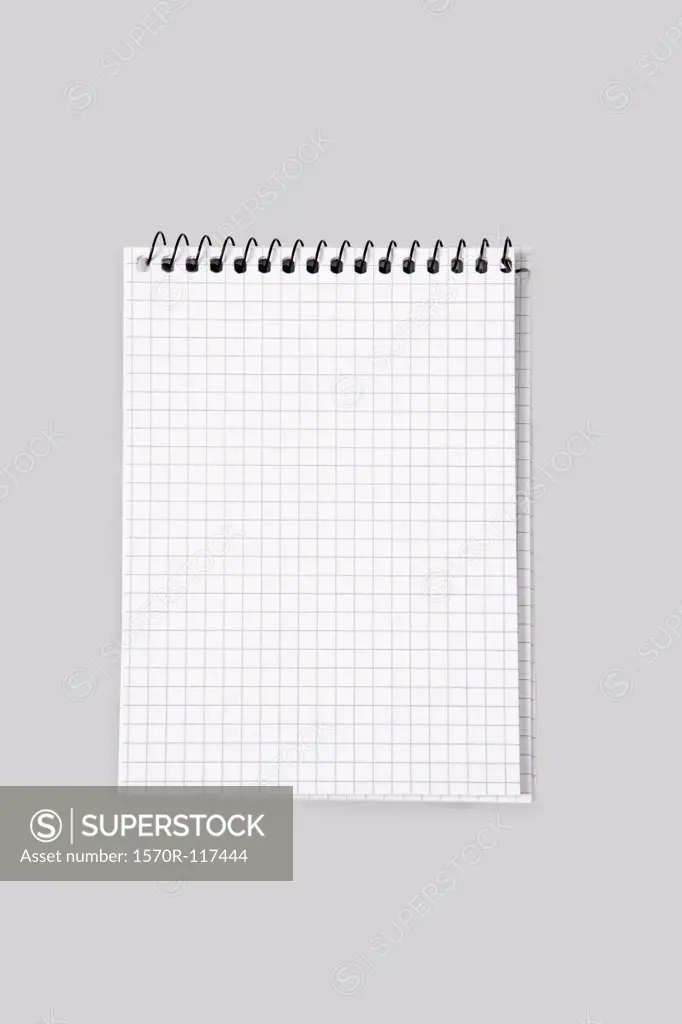 A spiral notebook with grid paper