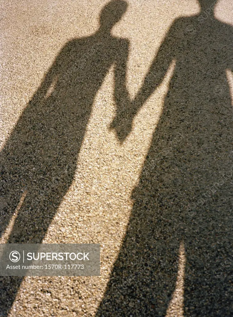 Shadow of a man and a woman holding hands