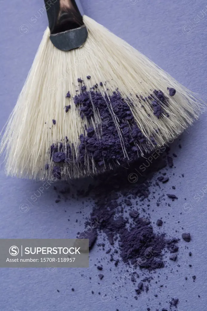 A make-up brush with purple eyeshadow