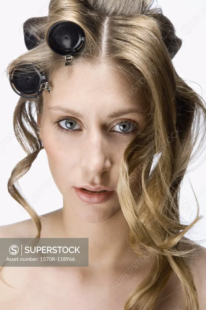 A woman wearing hair curlers