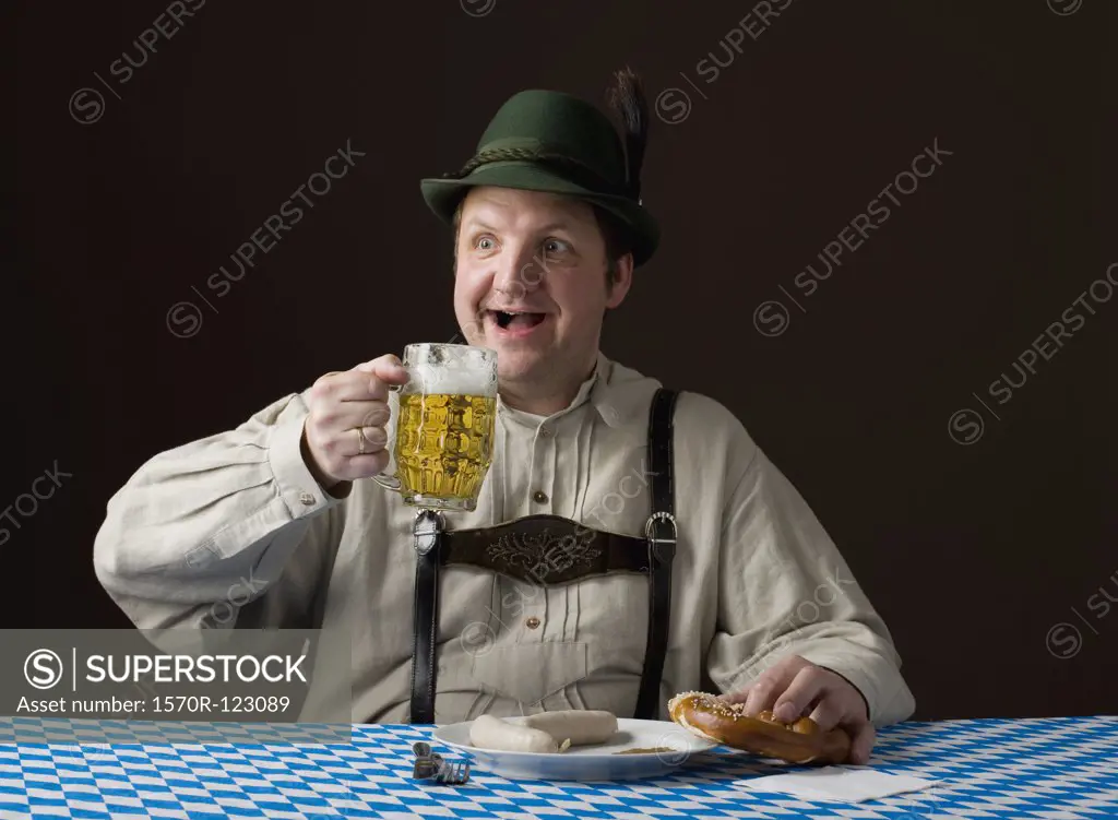 Stereotypical German man holding a beer and a pretzel