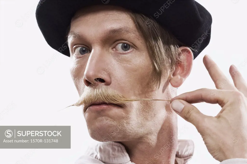 A man twisting his mustache