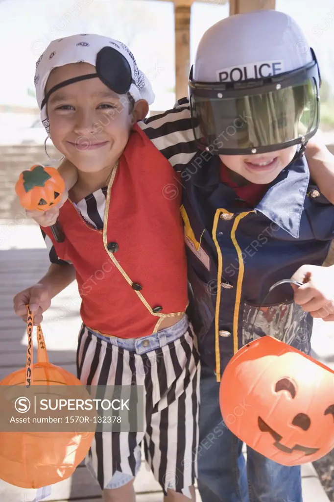 One boy dressed up as a pirate and another boy dressed up as a police officer for Halloween