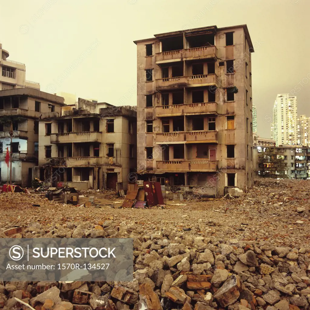 Abandoned buildings and rubble with modern high-rise buildings in background, Shenzhen, China