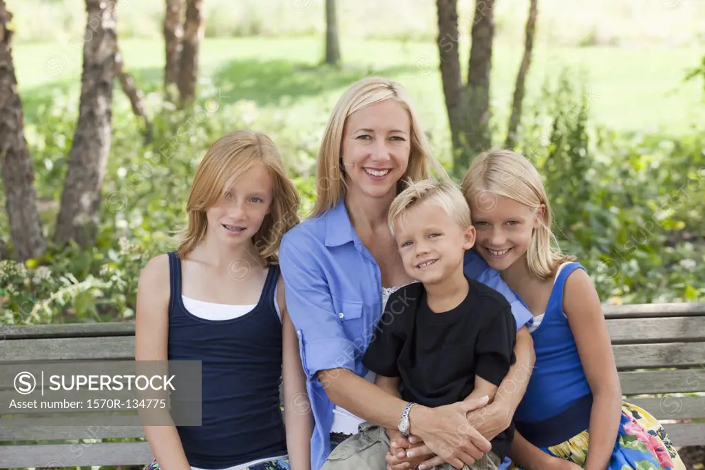 Mom and three kids on a bench