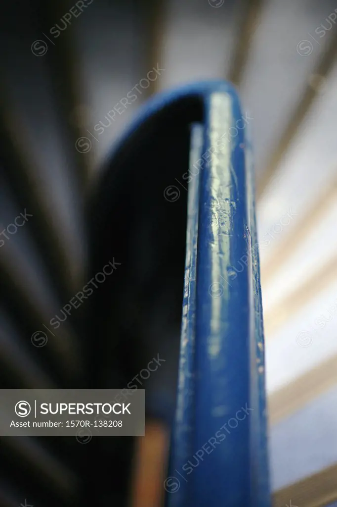 Blue handrail surrounded by spiral staircase