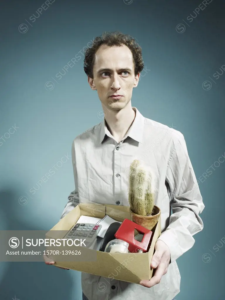 A man carrying a box of possession after being fired