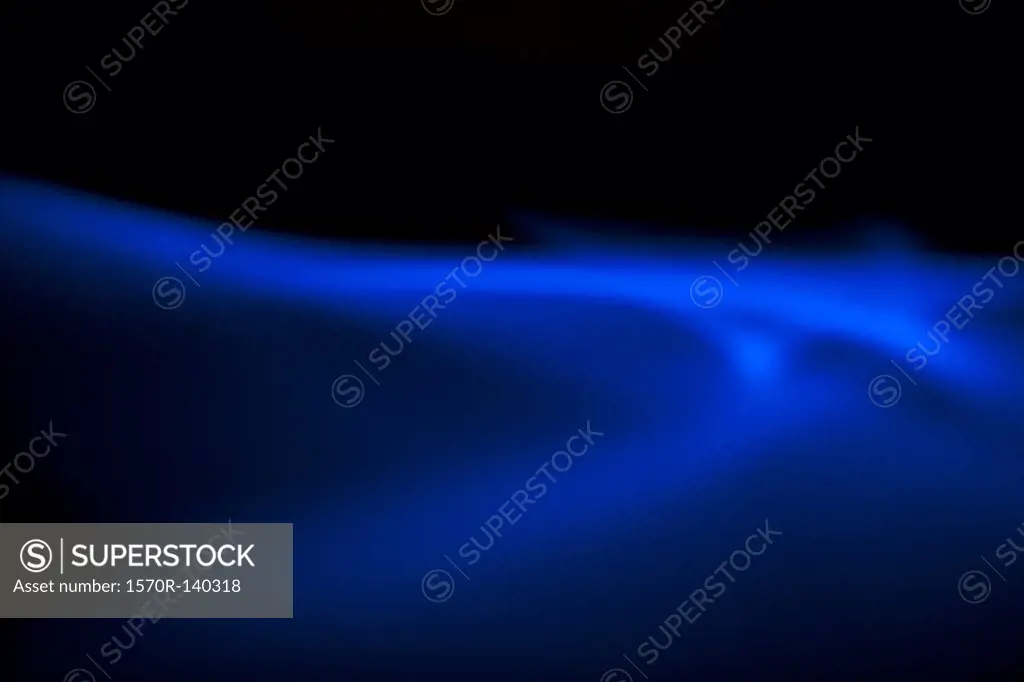 Blue light creating an ethereal effect on a black background