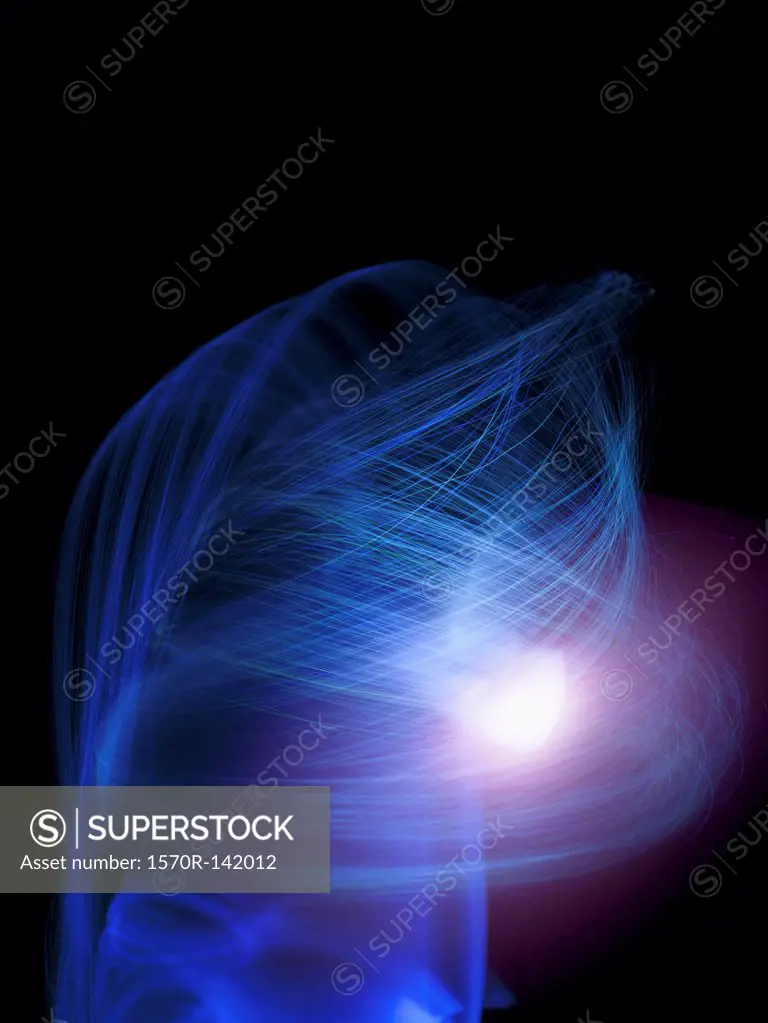 Blue and purple light trails creating fine line abstract spirals on black background