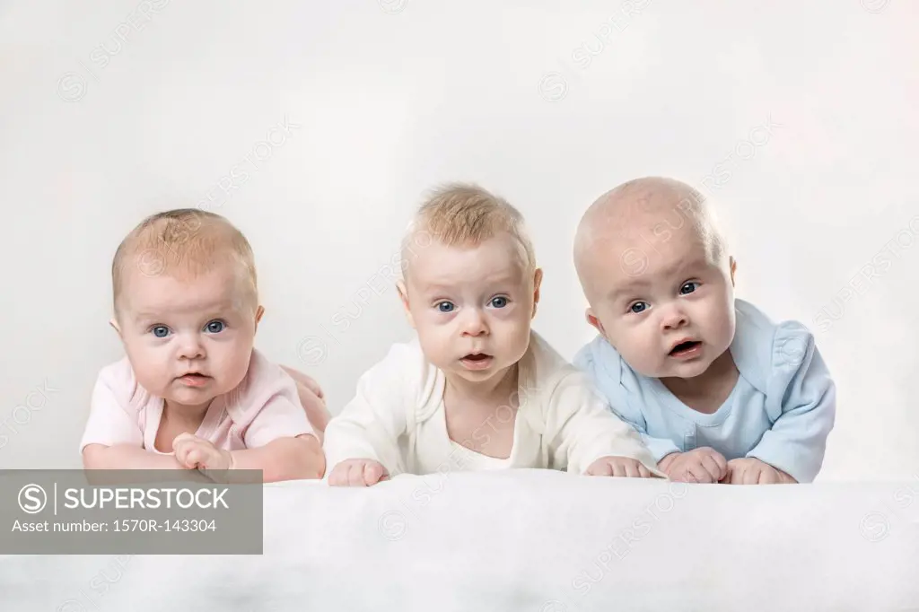 Three babies making funny faces