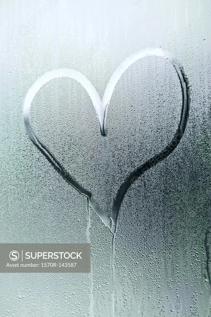 A heart shape drawn in the condensation of a window