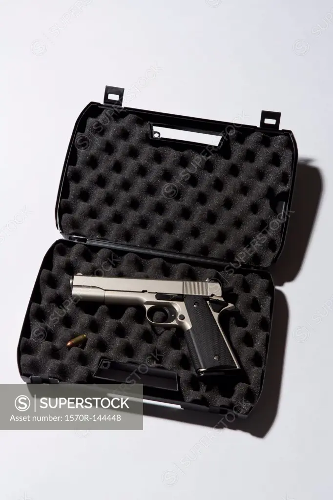 A handgun in a protected briefcase with a bullet