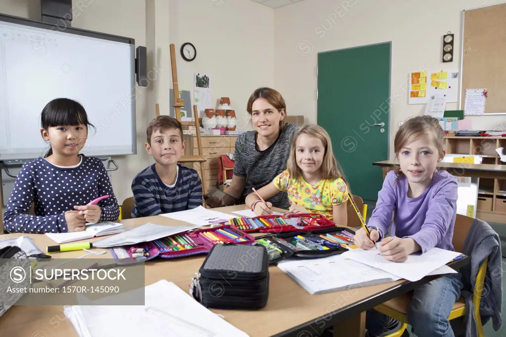 Teacher with students in classroom, portrait