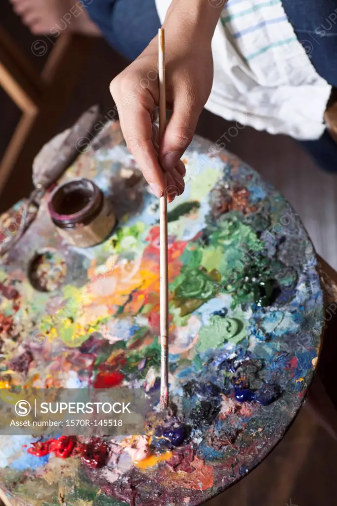 Female artist using palette, close-up