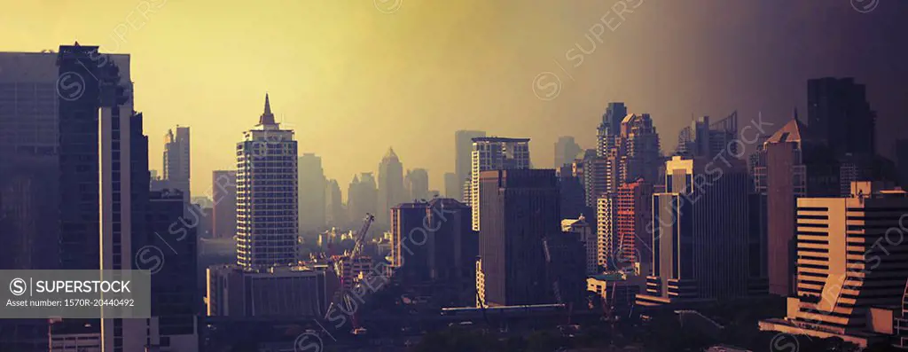 Modern buildings at Bangkok against sky during sunset, Thailand