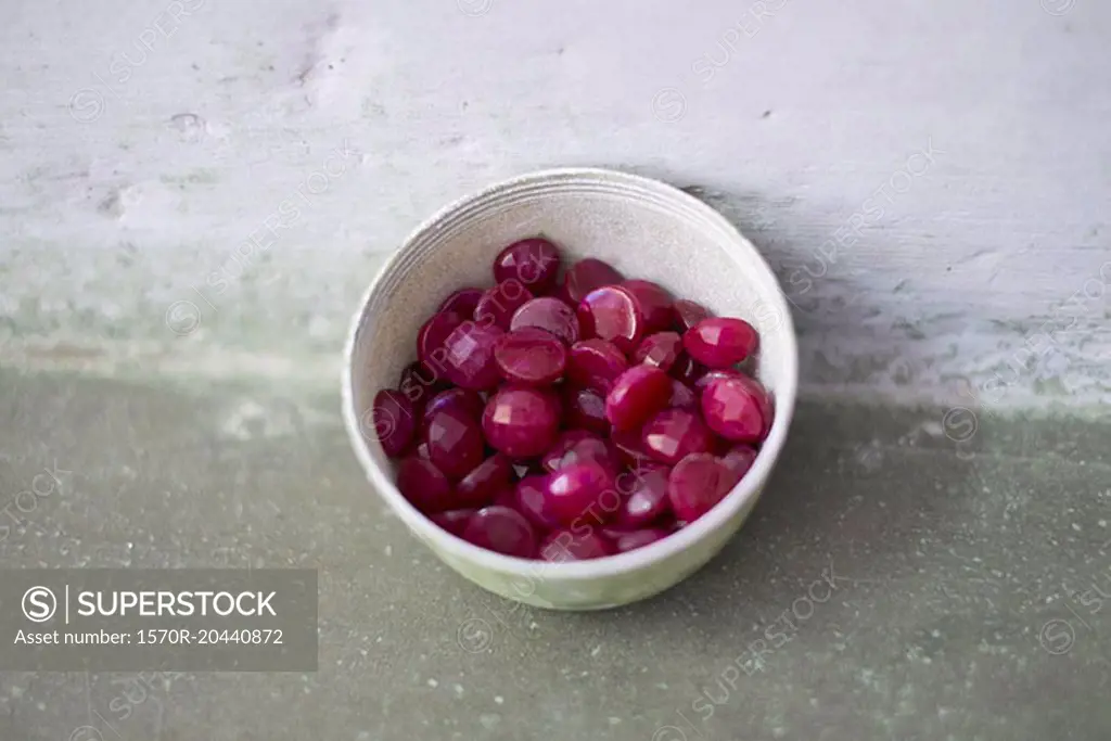 High angle view of gemstones in bowl on surface