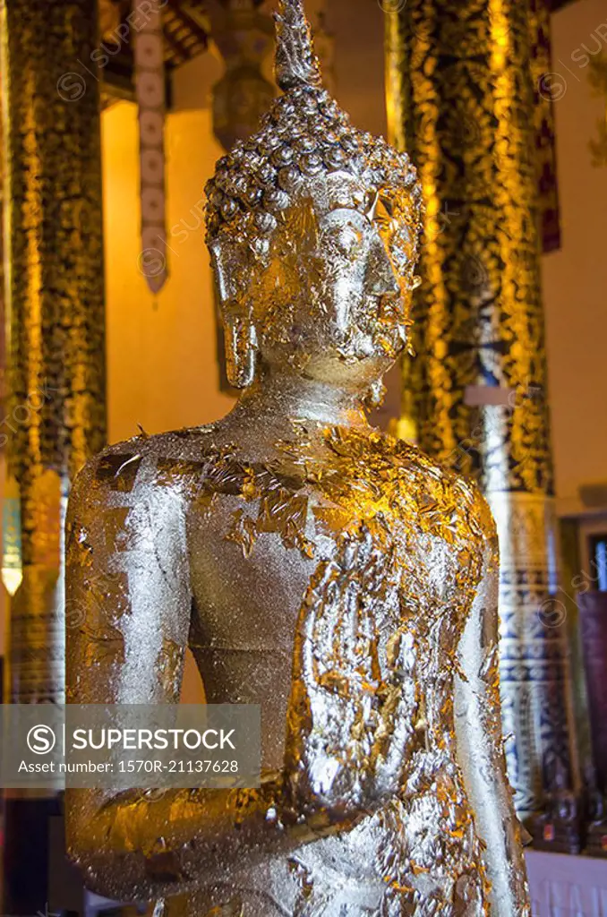 Foil on Buddha statue in temple