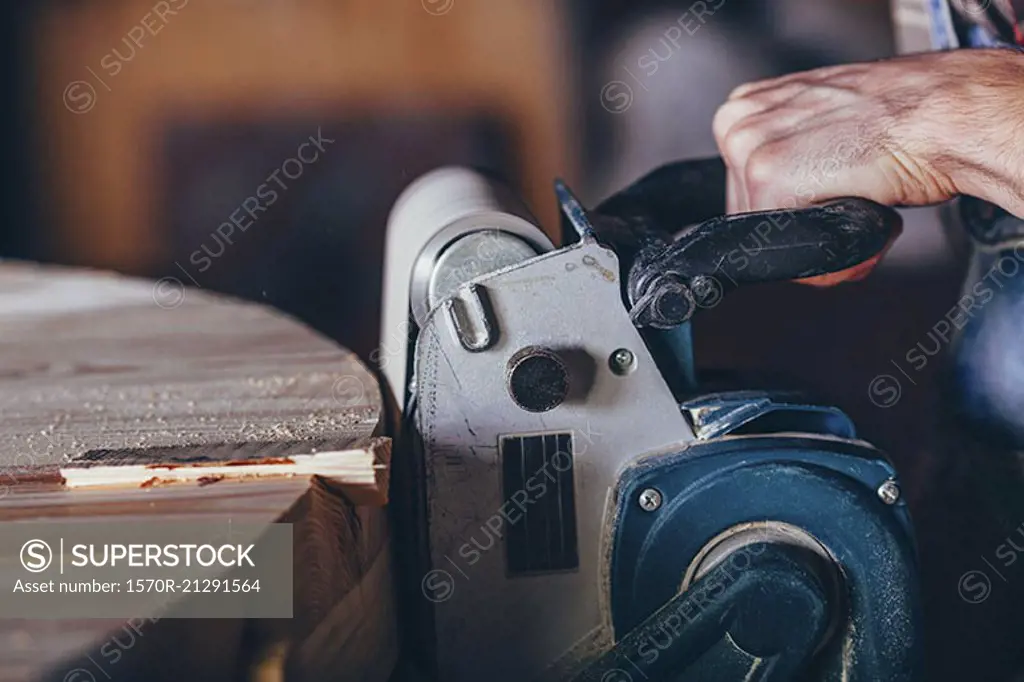 Cropped image of carpenter using sander on timber