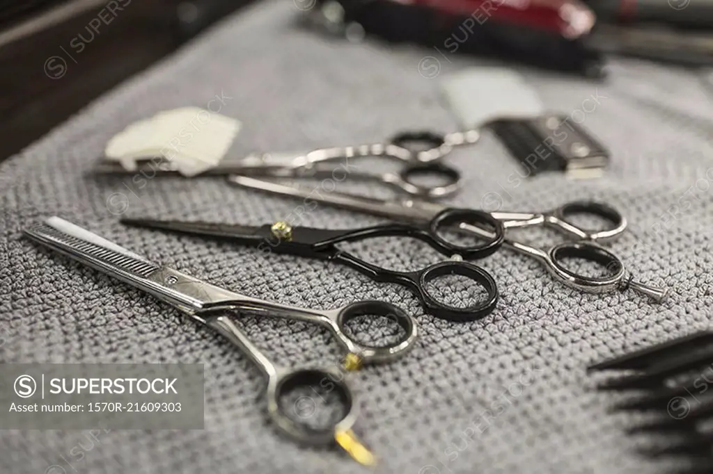 Close-up of various scissors on napkin at hair salon