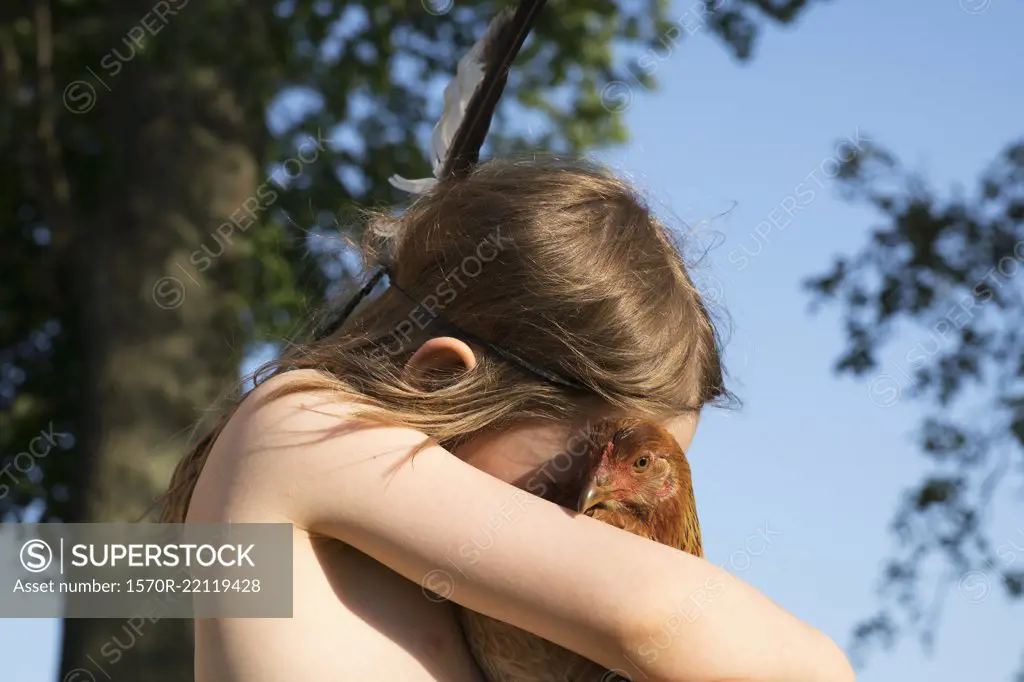 Girl hugging chicken