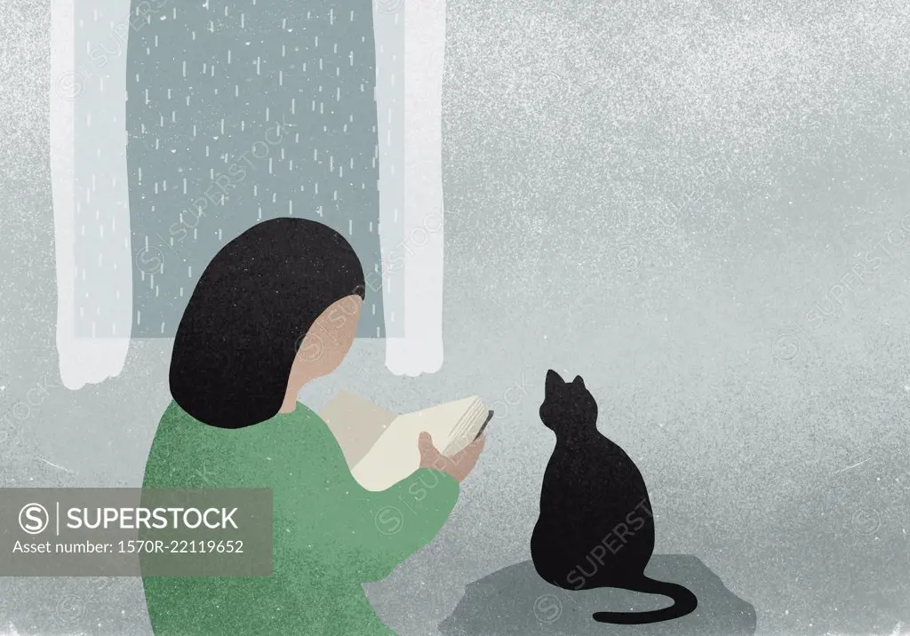 Woman with cat reading book next to rainy window