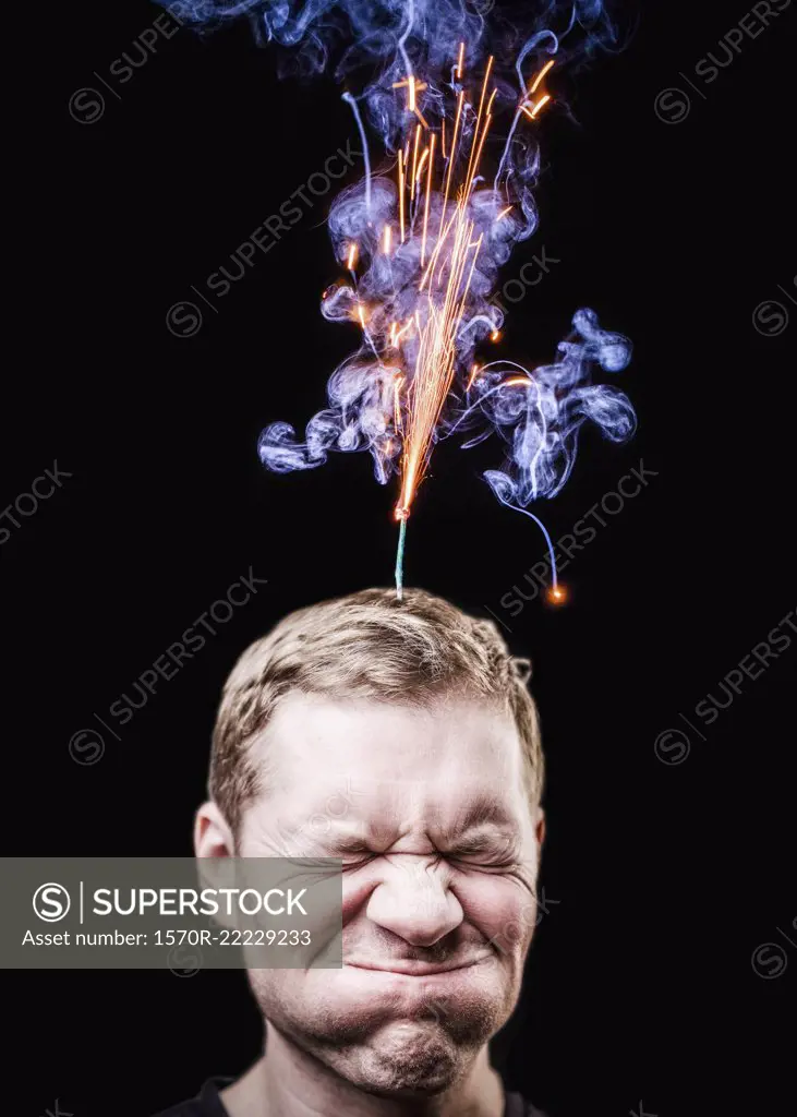 Fireworks emitting over mans head