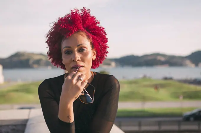 Portrait confident, serious woman with red hair