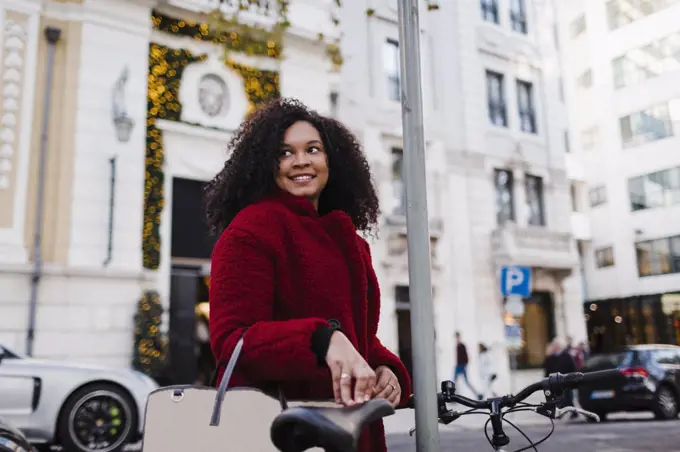 Happy young woman on urban street