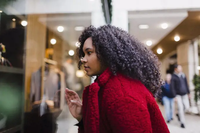 Young woman window shopping in mall