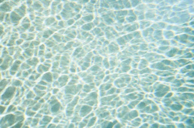 Reflection forming pattern over blue swimming pool water