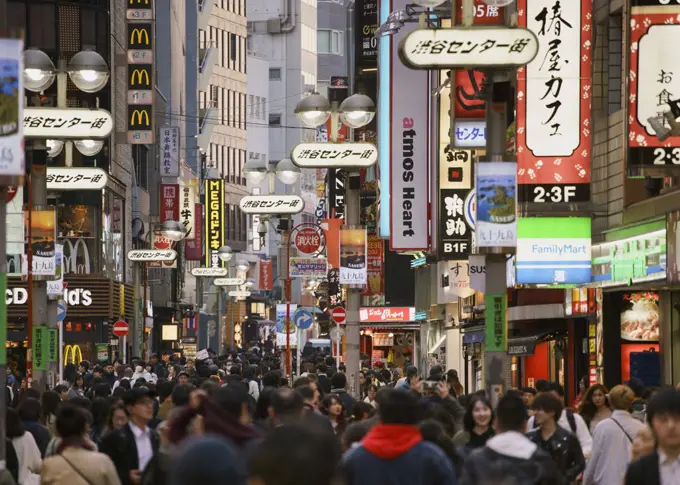 Pedestrians on bustling modern city street, Shibuya, Tokyo, Japan