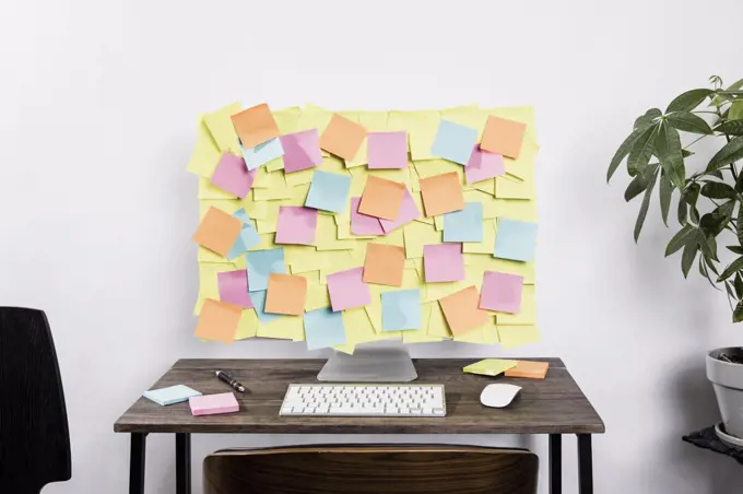 Adhesive notes covering computer in office