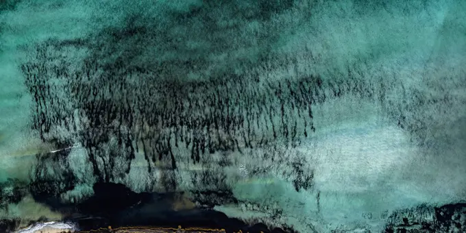 Aerial view vibrant turquoise ocean at the beach of Es Trenc, Majorca, Spain