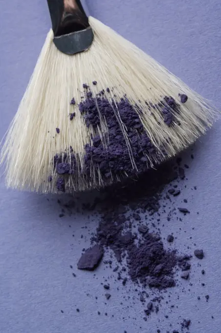 A make-up brush with purple eyeshadow