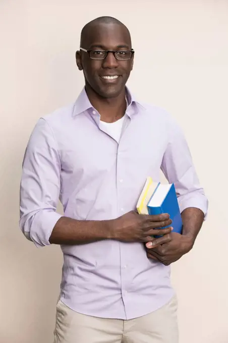 Studious man holding books