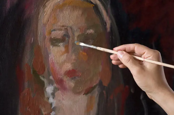 Female artist painting, close-up