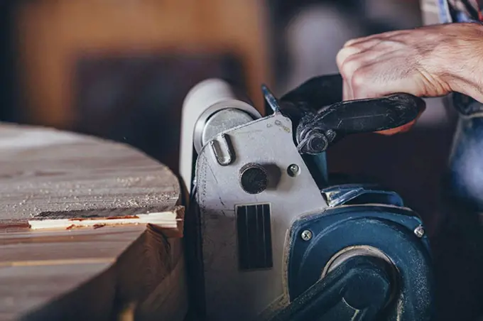 Cropped image of carpenter using sander on timber