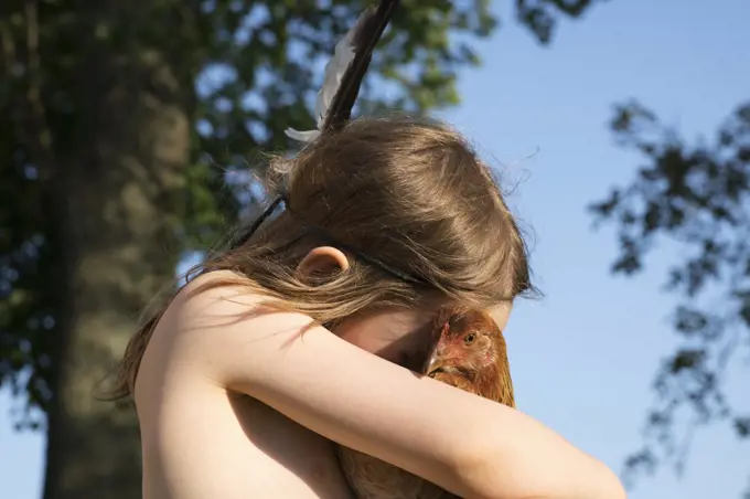 Girl hugging chicken