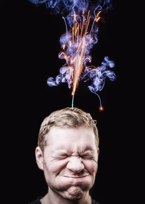 Fireworks emitting over mans head