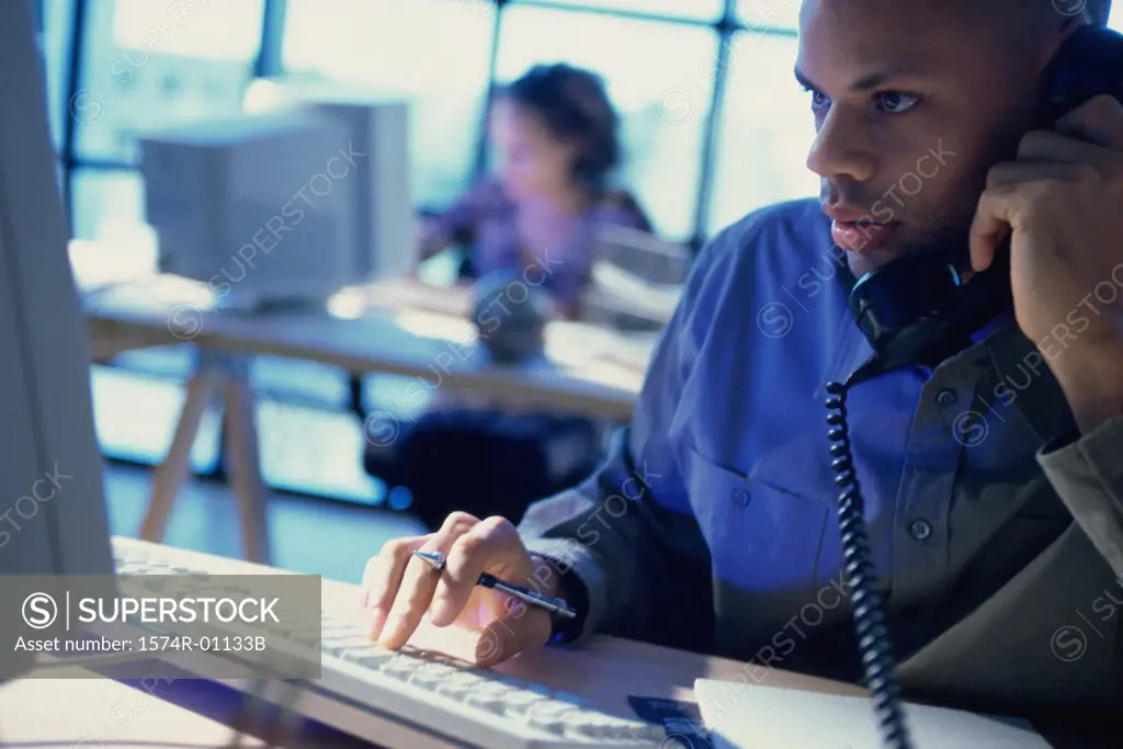 Businessman talking on a landline telephone