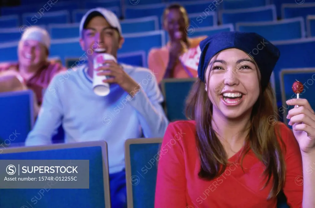 Four teenagers sitting in a movie theater