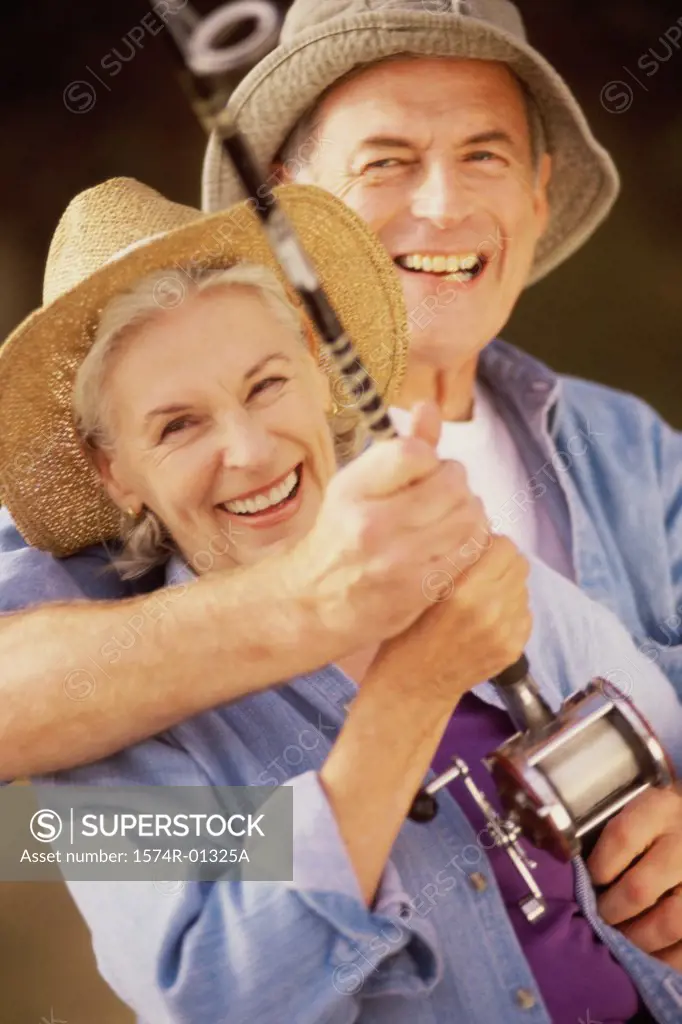 Portrait of a senior couple holding a fishing rod