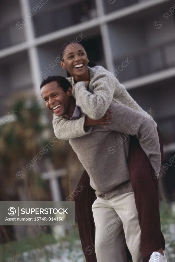 Mature woman riding piggyback on a mature man