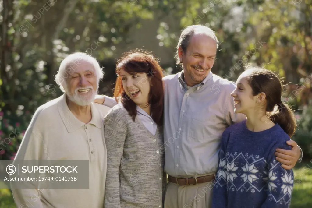 Close-up of three generation family standing together