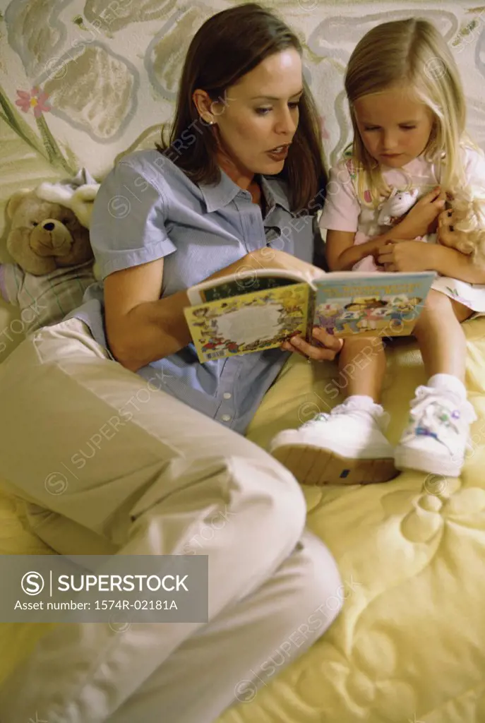 Mother reading a book with her daughter