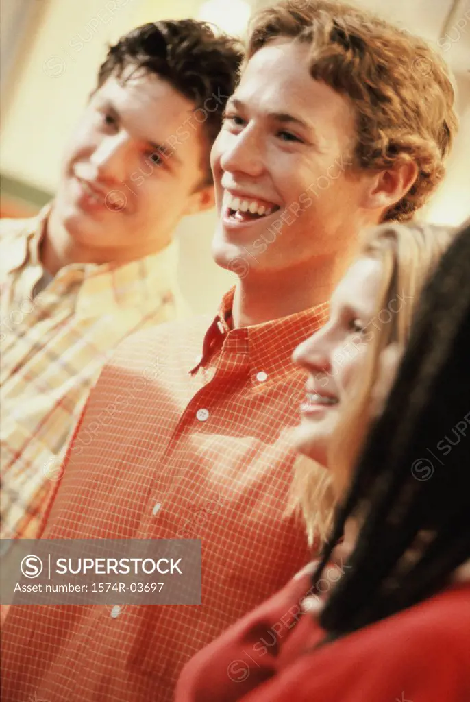 Close-up of two teenage boys and a girl smiling