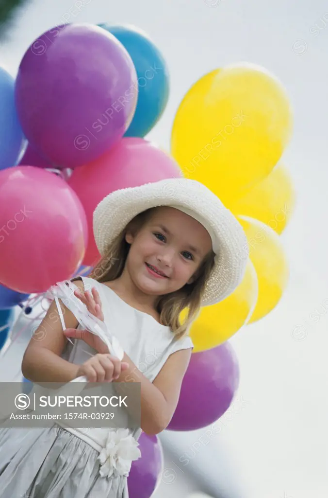 Portrait of a girl holding balloons