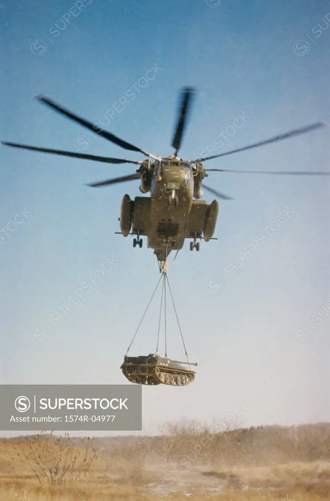 Low angle view of CH-53D Sea Stallion lifting a tank