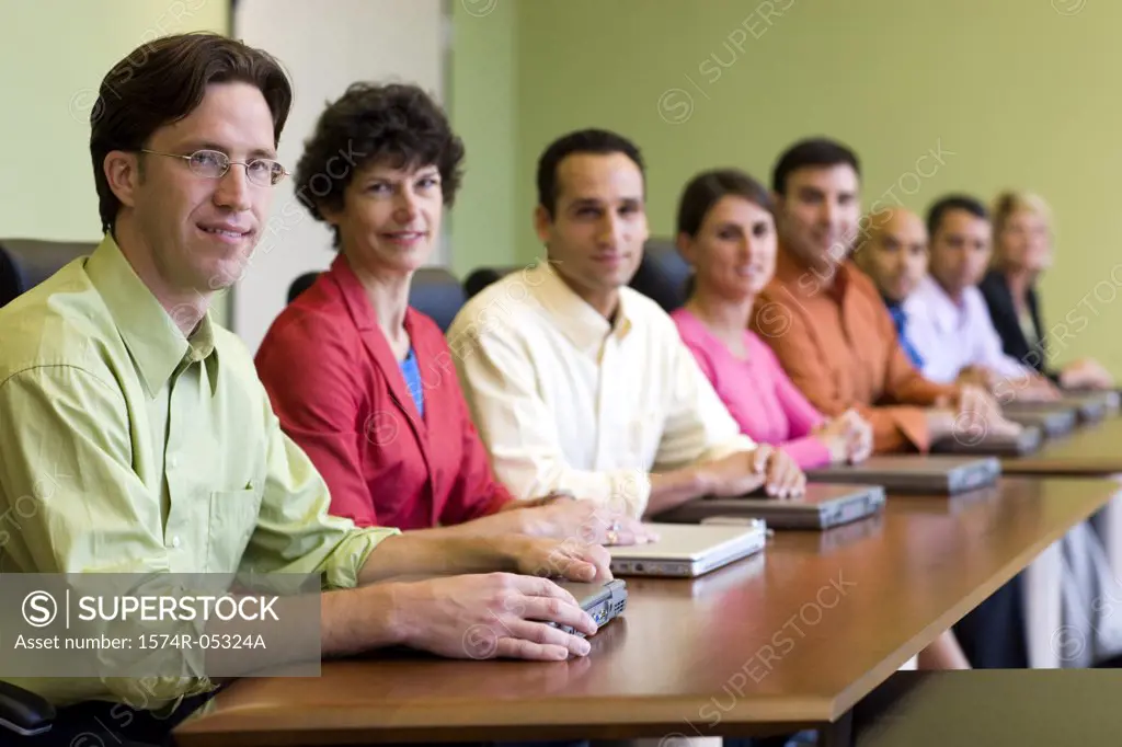 Portrait of a group of business executives sitting around a conference table